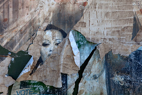 Feminine face on a torn poster- © Norbert Pousseur