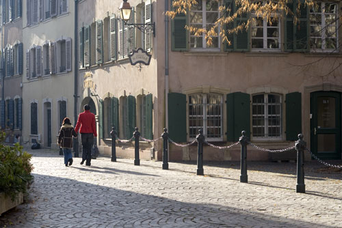Passers-by in timeless quiet street - © Norbert Pousseur