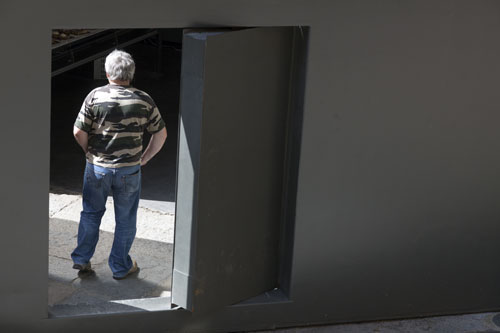 Man in the door of the closed down church  St Marie - Sarlat - © Norbert Pousseur