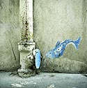 Small blue fish jumping into a pipe of street - Graph'wall - © Norbert Pousseur